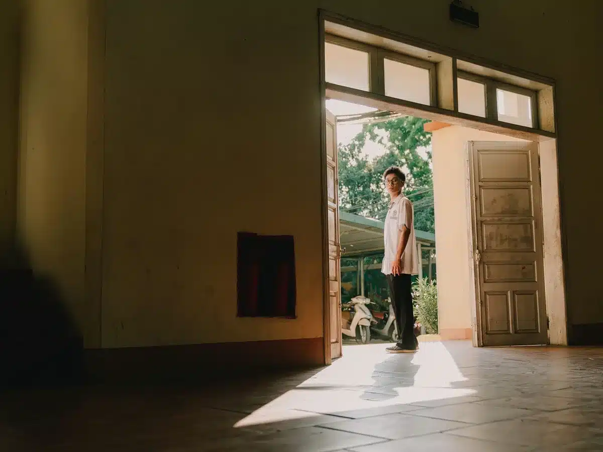 Hallway scene at a high school building where tension and conflict emerge unexpectedly