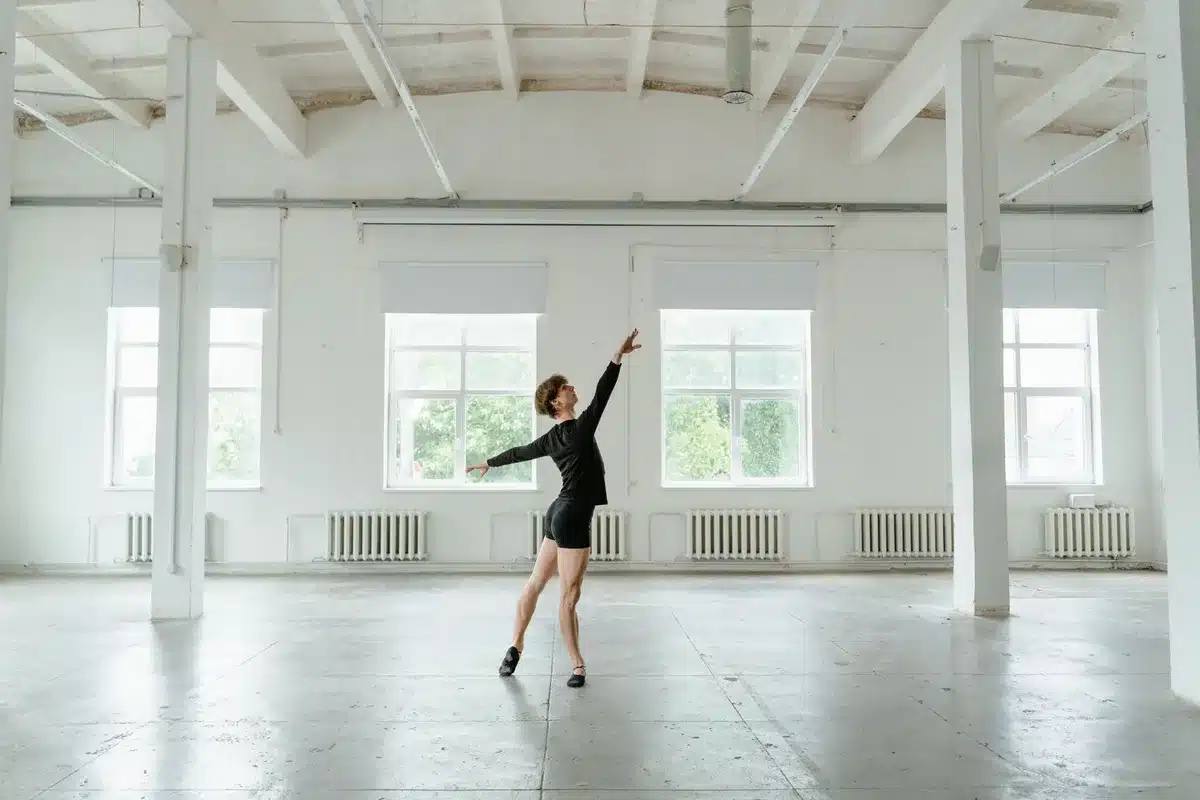 Dancer sustaining accidental contact during group choreography rehearsal in studio