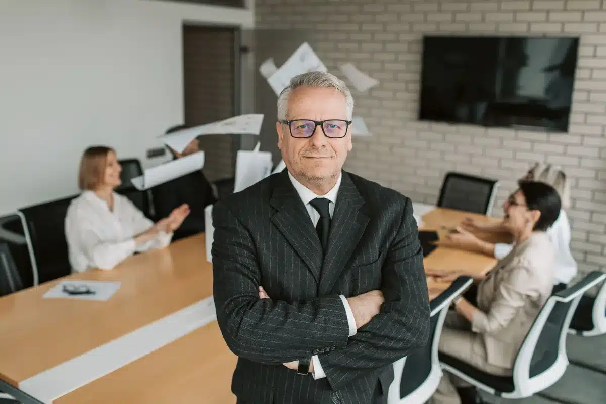 Anonymous business executives in a modern office conference room reviewing documents during a meeting