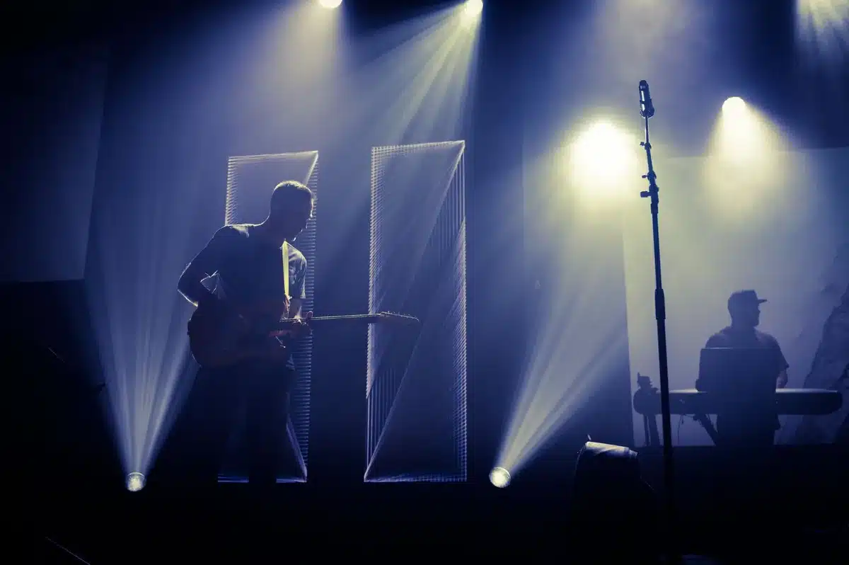 Live band performing on stage with instruments during a concert