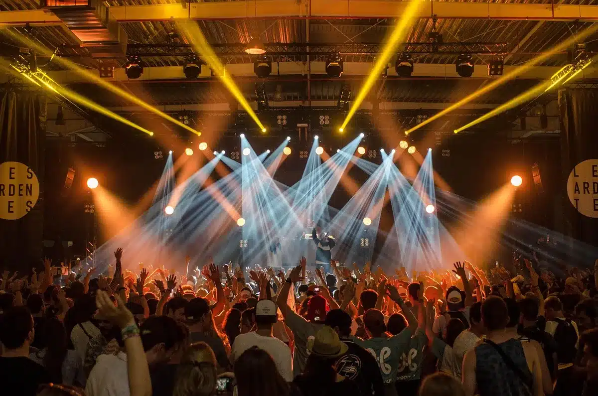 A live concert stage with lighting during a performance, representing touring and streaming momentum
