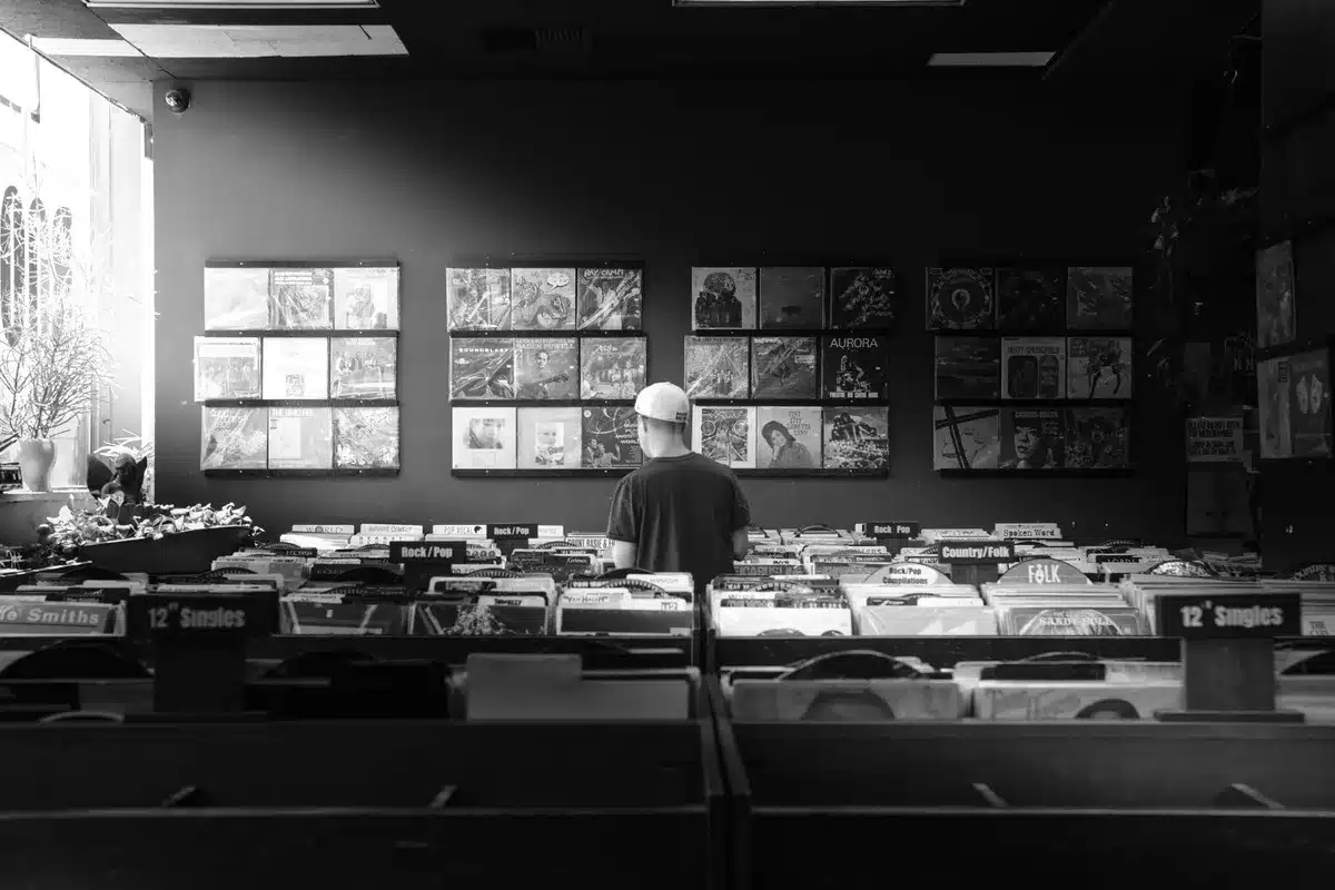 Blurred record label office with legal documents and streaming platform icons in background