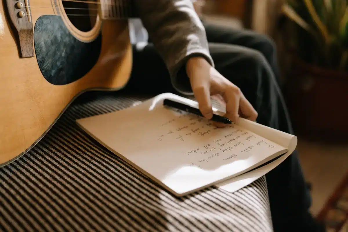 Songwriter's notebook and guitar during songwriting session