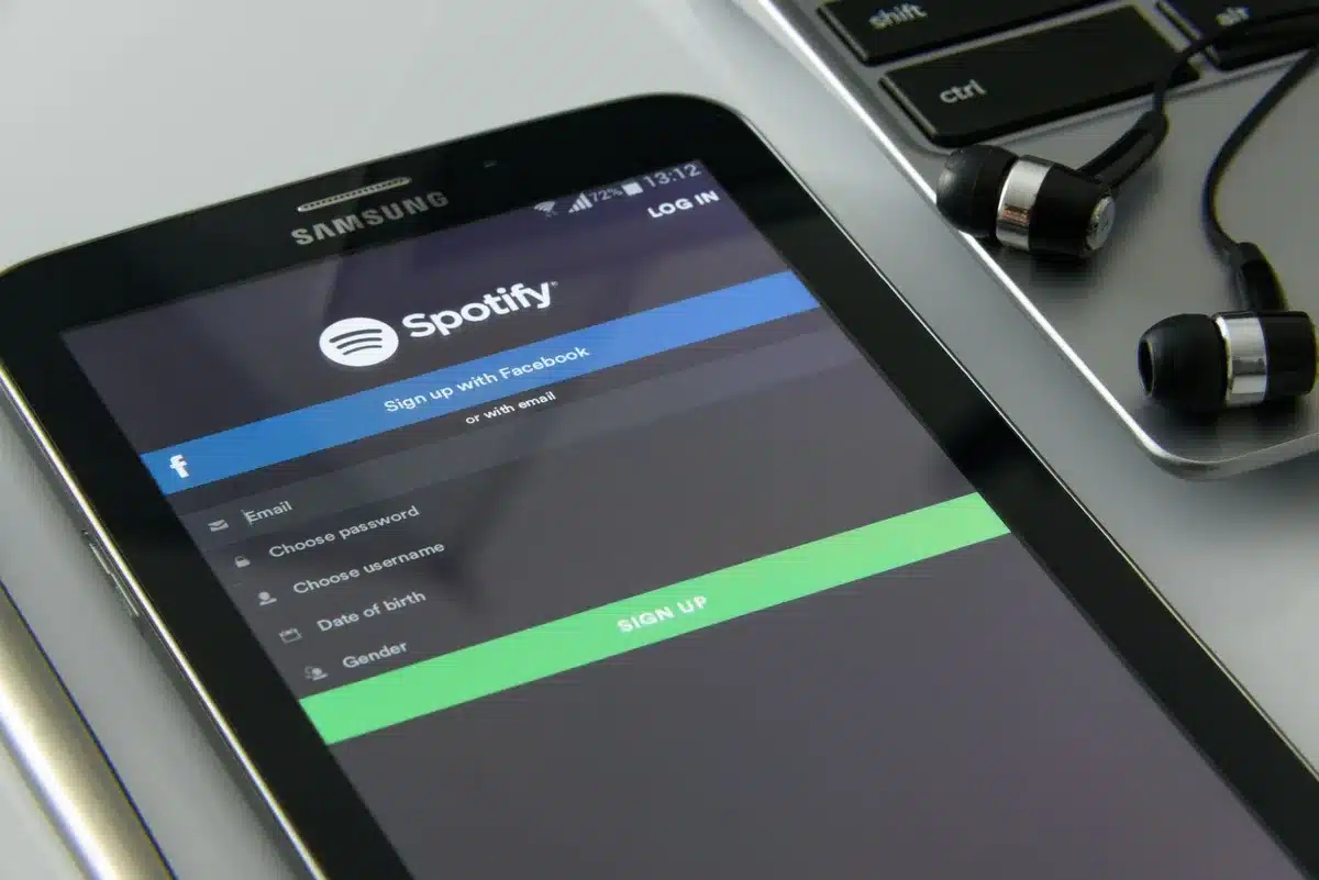 People using phones and devices to stream music, with chart data and competition visible