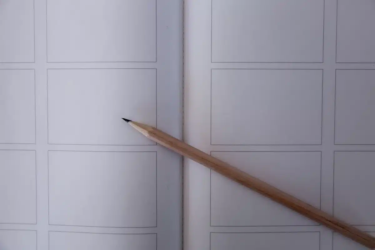 Comic book pages showing pencil and ink work-in-progress stages