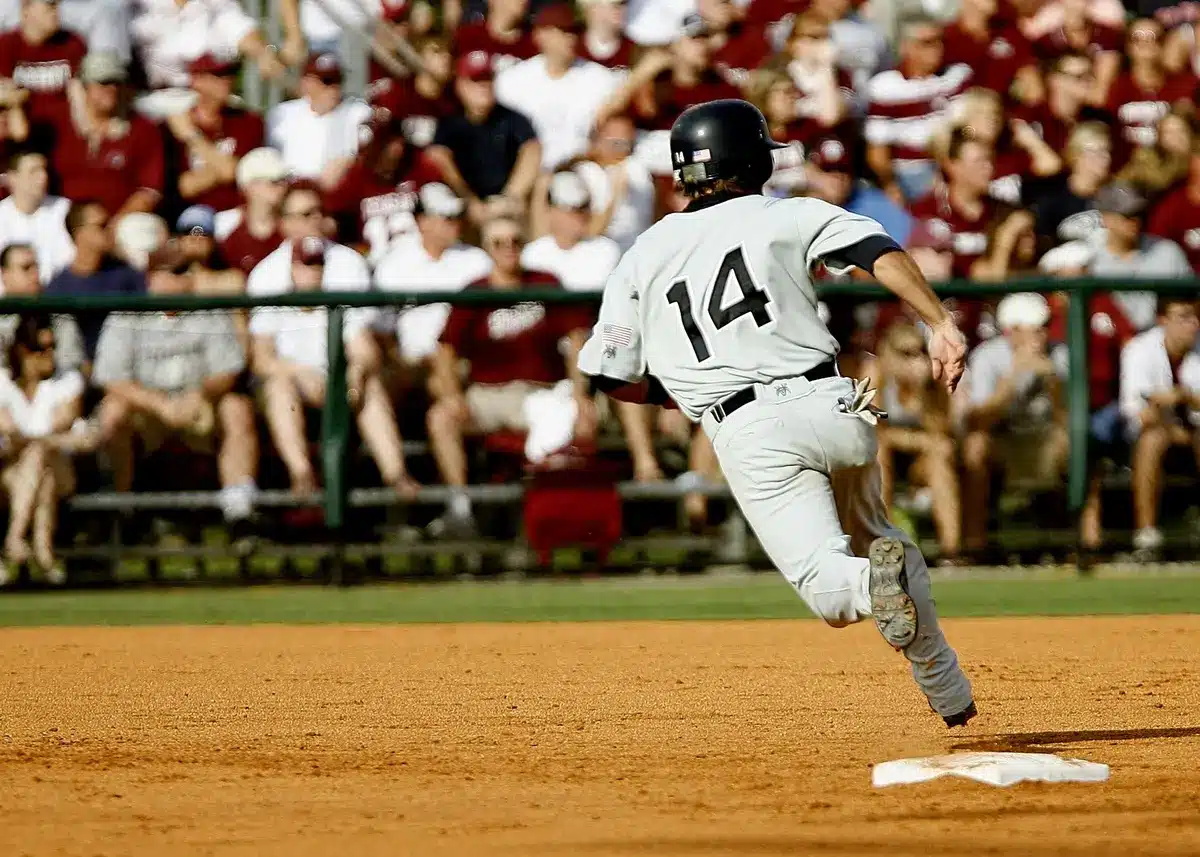 Baseball player rounding bases after hitting a home run