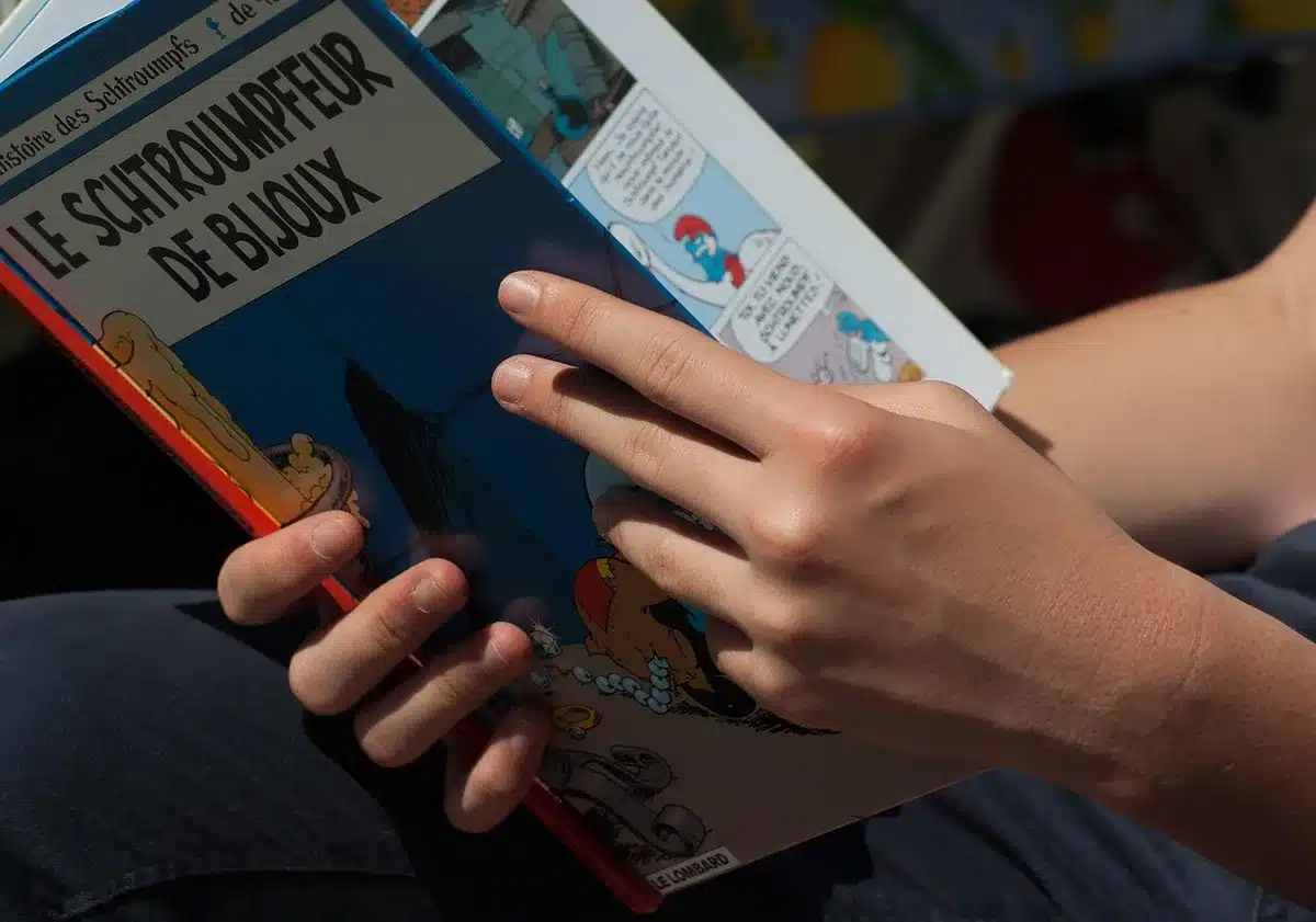 A dealer's hands examining a slabbed vintage comic book under professional lighting