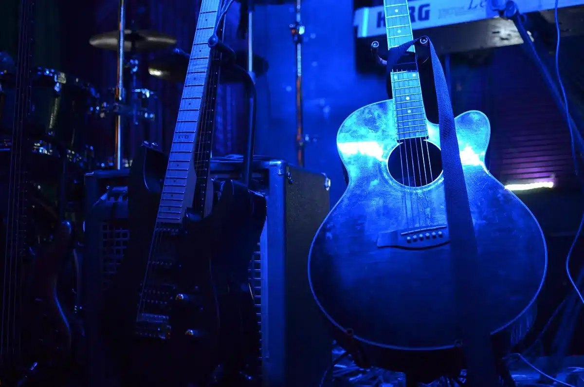 Guitarist playing on stage with intense lighting