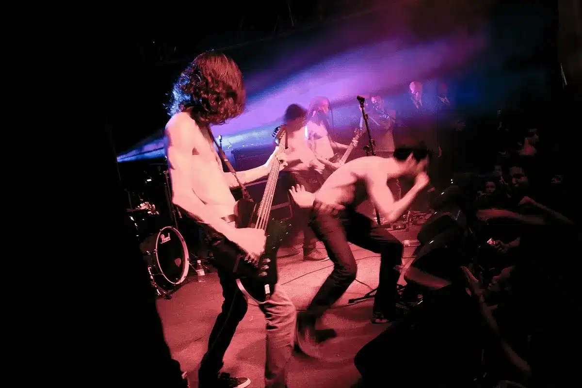 Crowd and band onstage at an outdoor festival