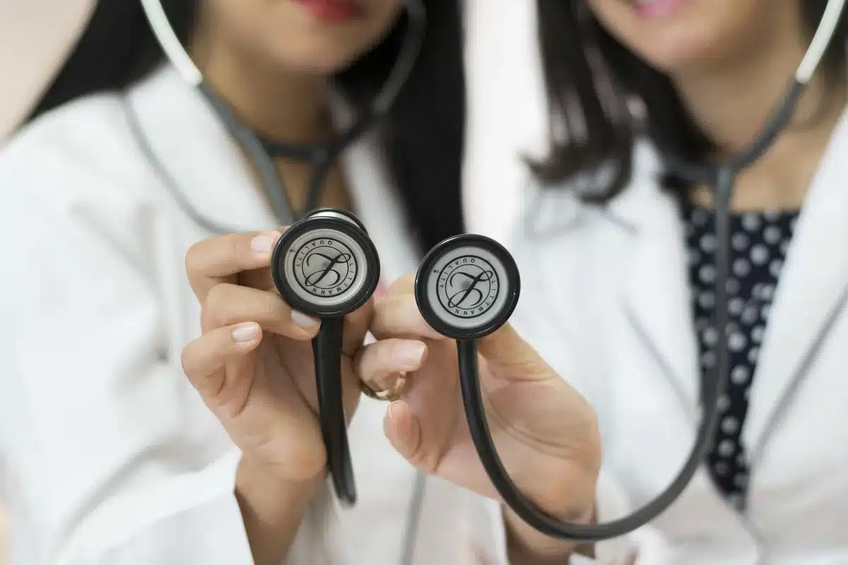 Doctors in a tense discussion around a table, showing workplace conflict