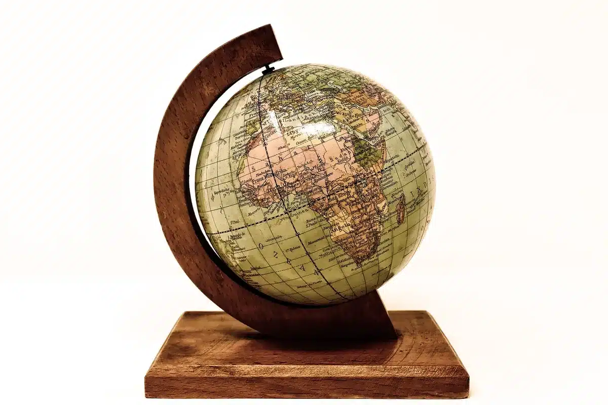 A globe or world map with travel-themed visual elements, passport, and destinations marked