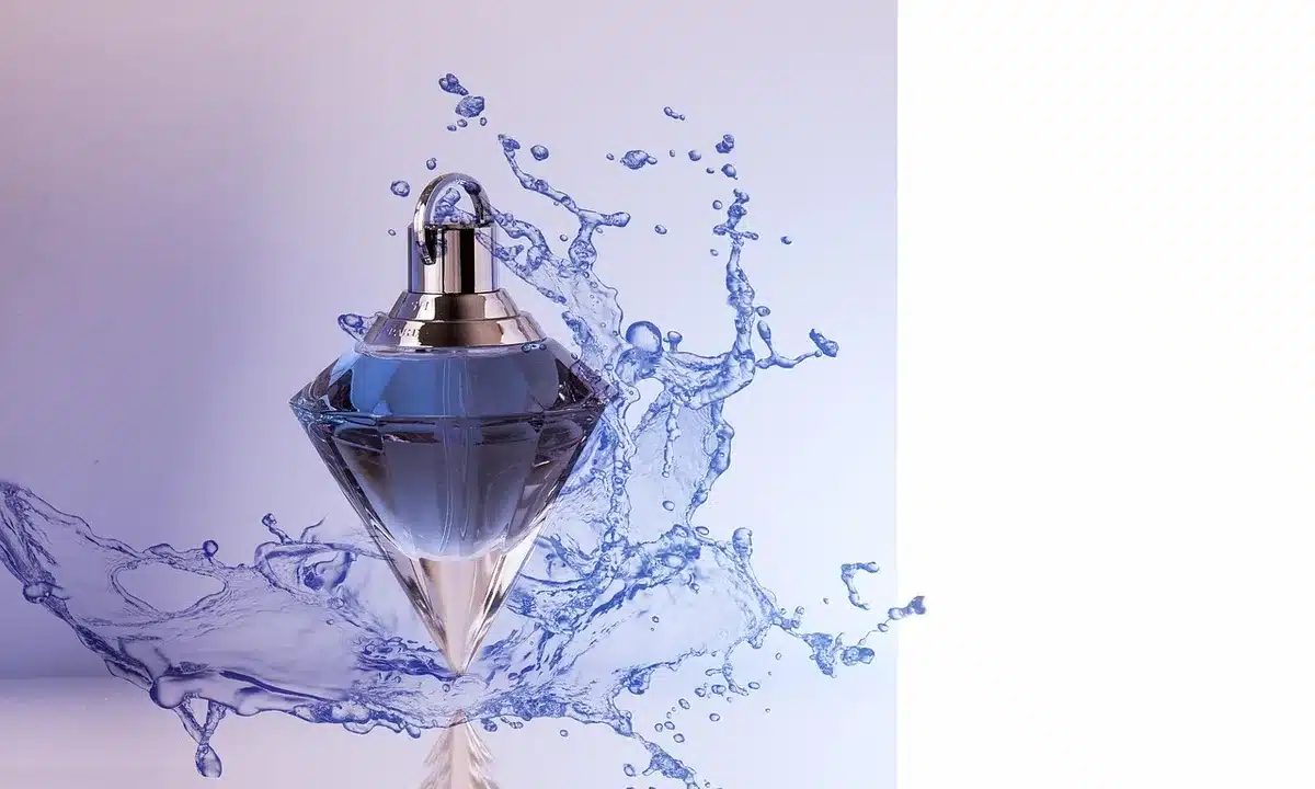Translucent fragrance bottle with creamy, luminous liquid catching soft light, minimalist aesthetic, gentle shadows