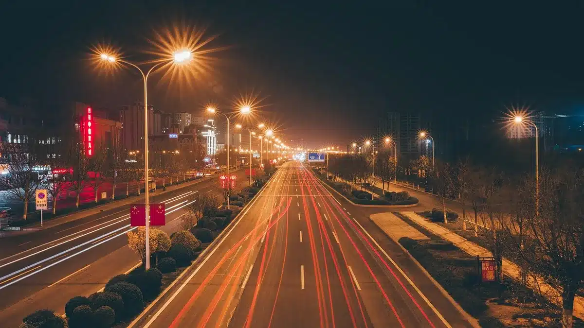 Two women near a car at night suggesting fugitives on the run