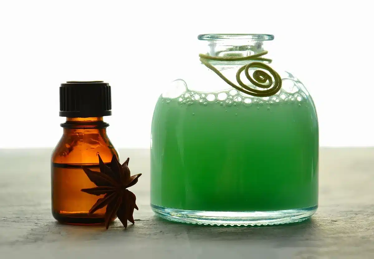 A close-up of a vintage medicine bottle and an open script page on a wooden table, anonymous hands blurred at the edge; no branding