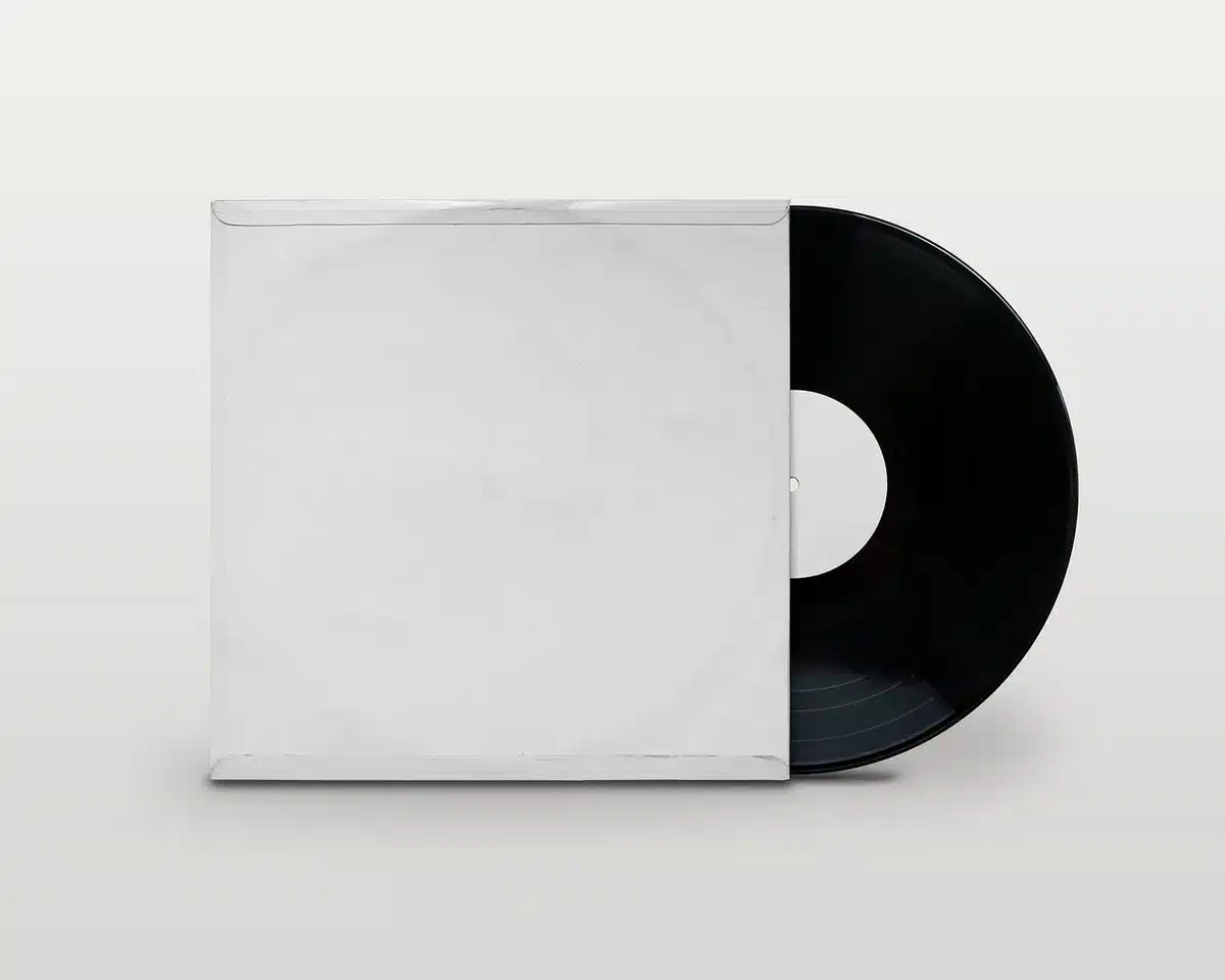 Vinyl records, headphones and album artwork arranged on a studio table with soft lighting