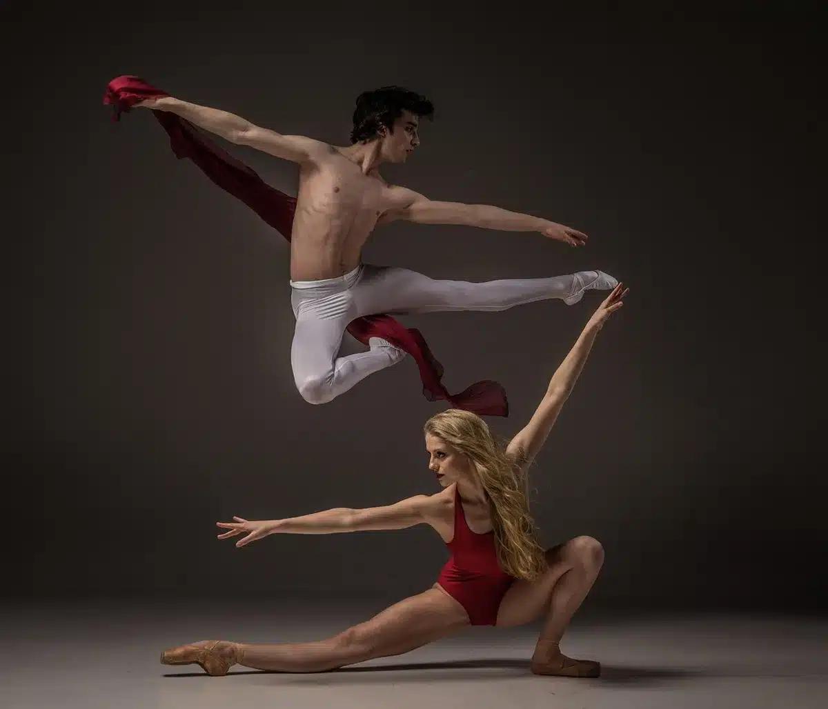 Ballet dancers performing on a city sidewalk in casual clothes