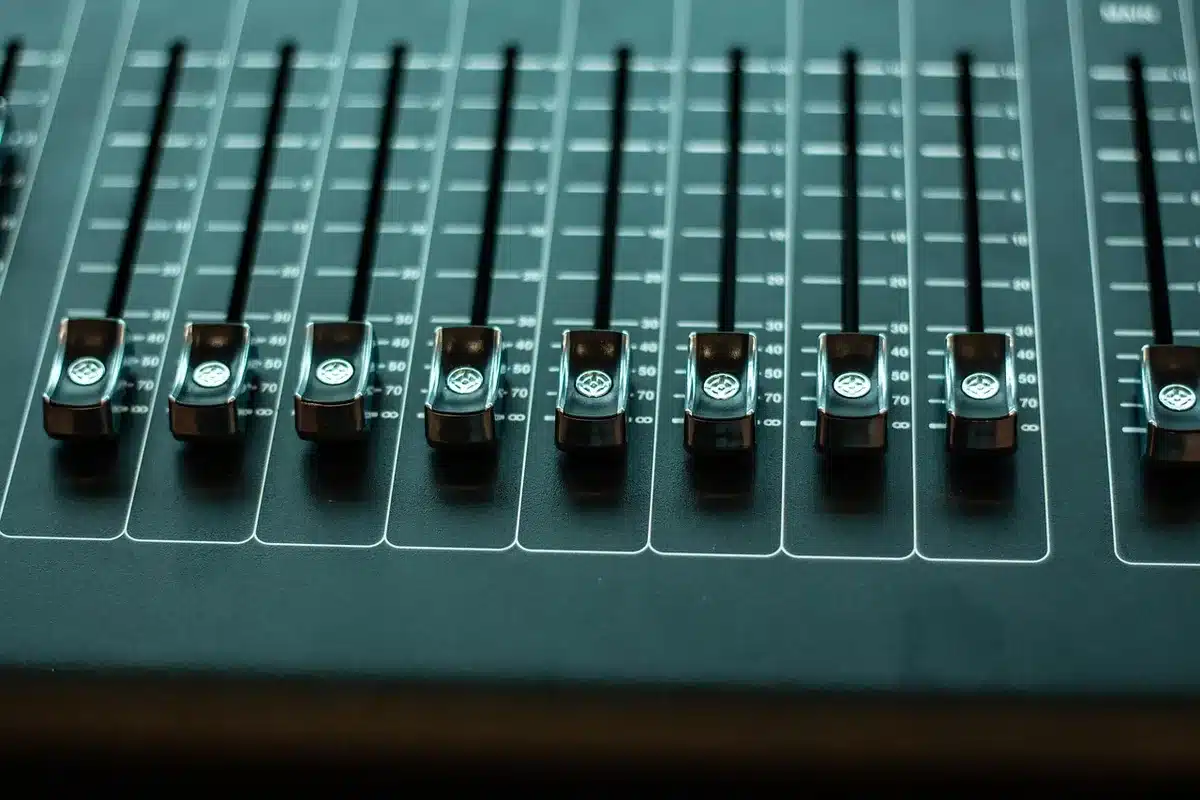 Producer at a mixing console shaping atmospheric beats