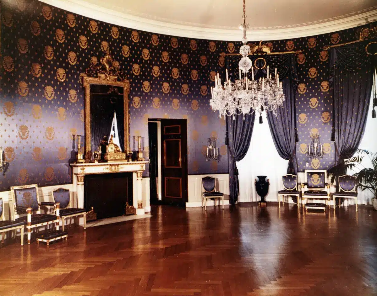 Silhouette of a suited figure behind a presidential desk, anonymous and non-identifiable