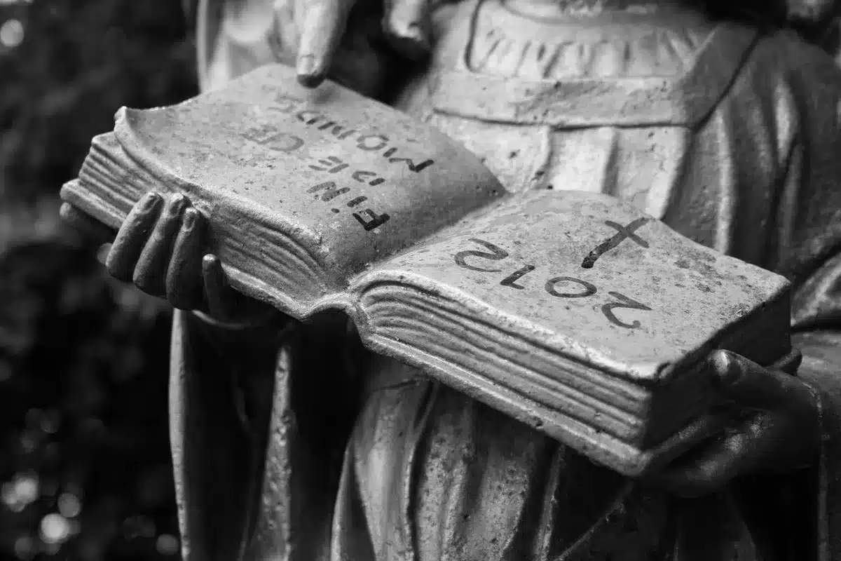 Hands paging through a vintage comic on a wooden table with an auction tag