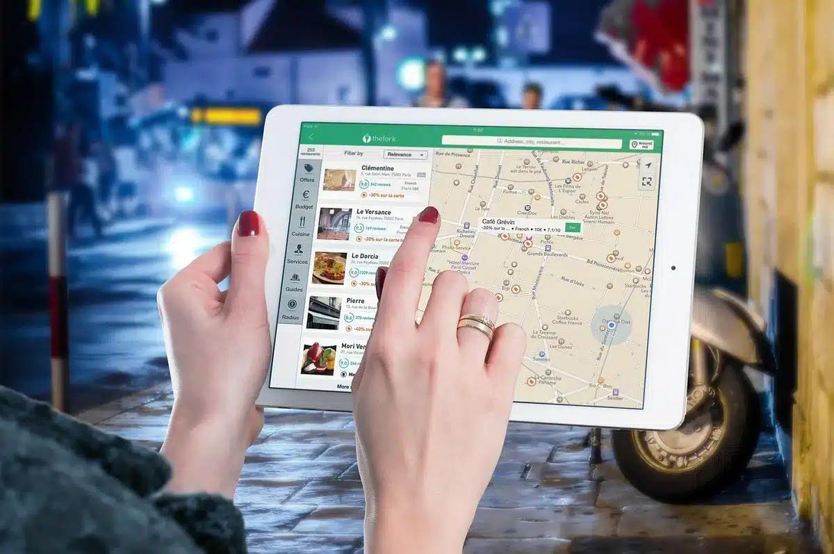 A digital mobile app interface displaying a convention floor map with vendor locations, panel schedules, and photo op times highlighted in an interactive layout.