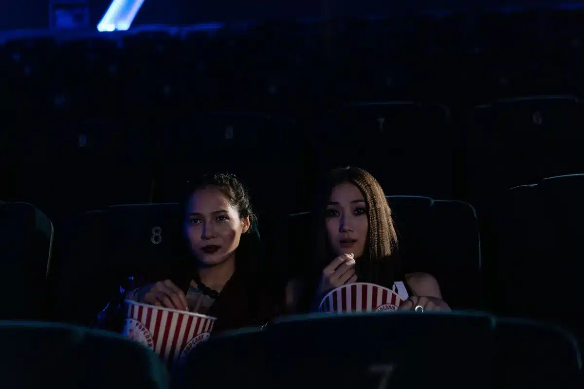 Crowd at a midnight movie screening in a darkened theatre