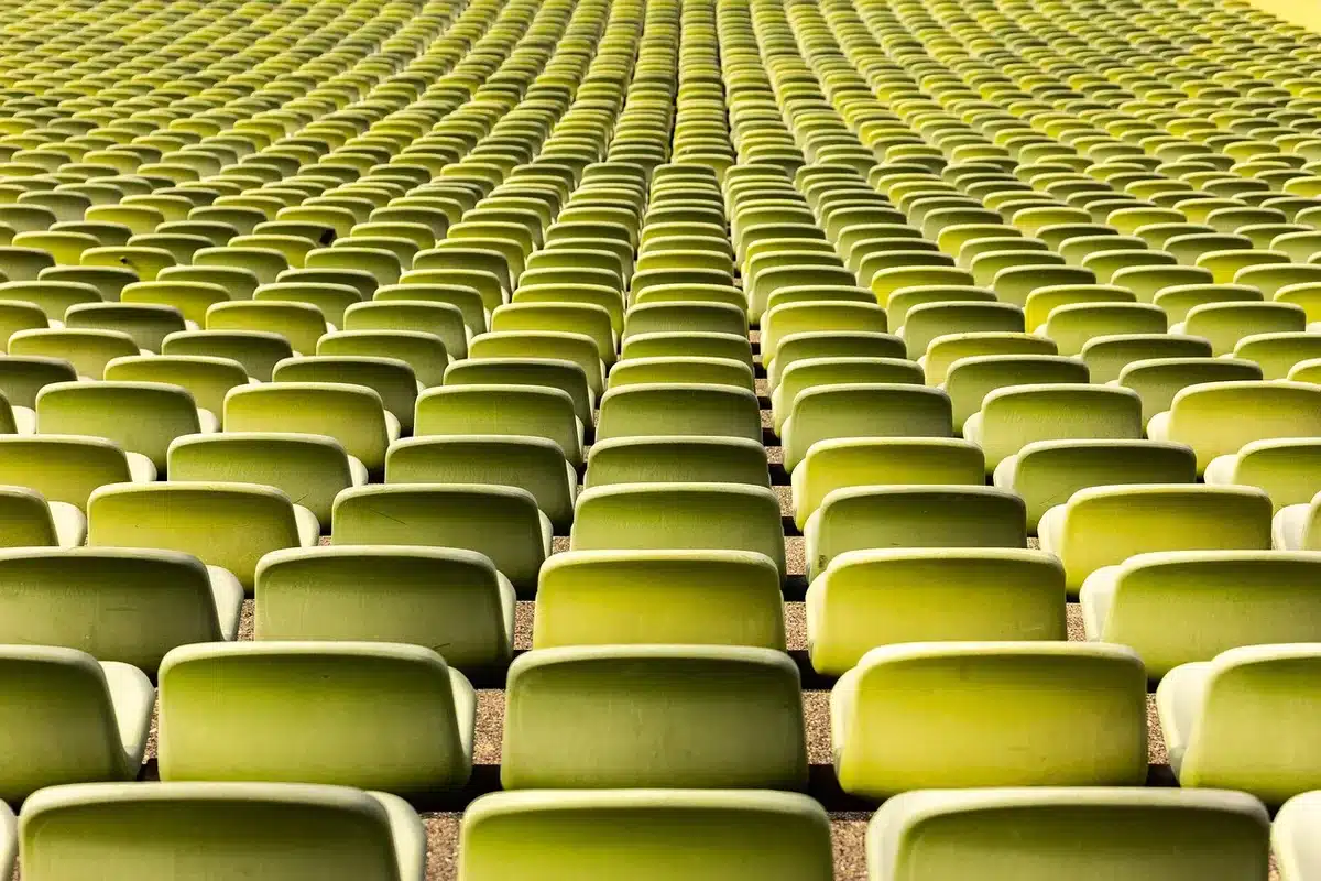 Audience leaving a cinema auditorium with murmuring crowd outside