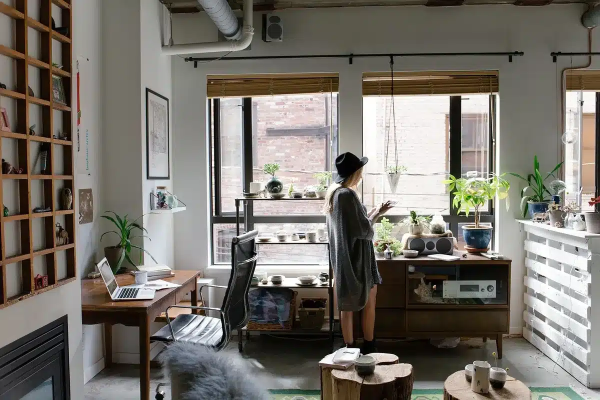 A designer's studio workspace with colorful fabric swatches, sketches, and origami-inspired garment samples spread across a work table, vibrant vintage cartoon color palettes visible.