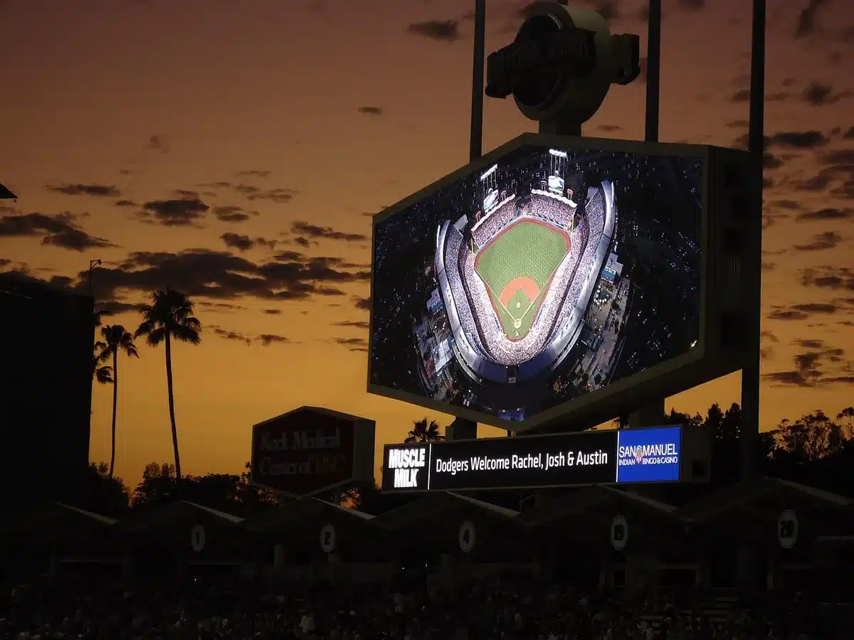 Stadium scoreboard and crowd during a night broadcast