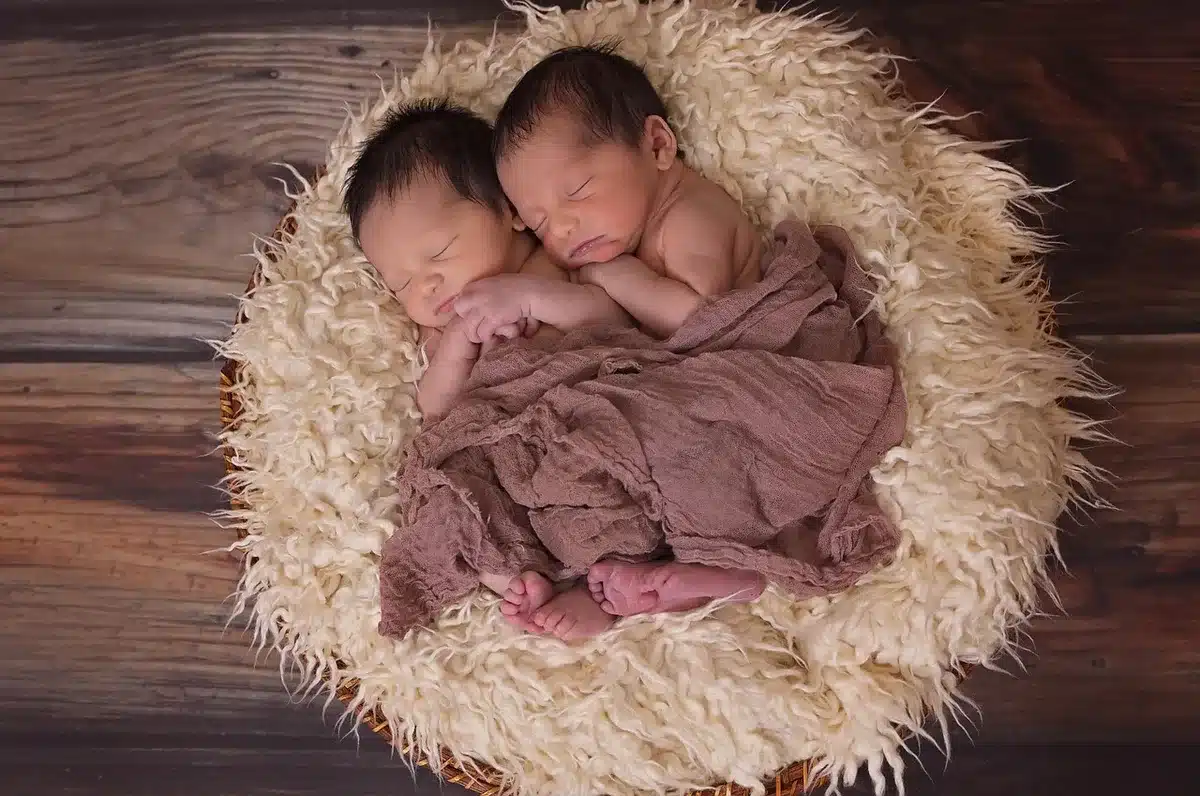Polaroid-style photos of a newborn and parents laid out on a surface