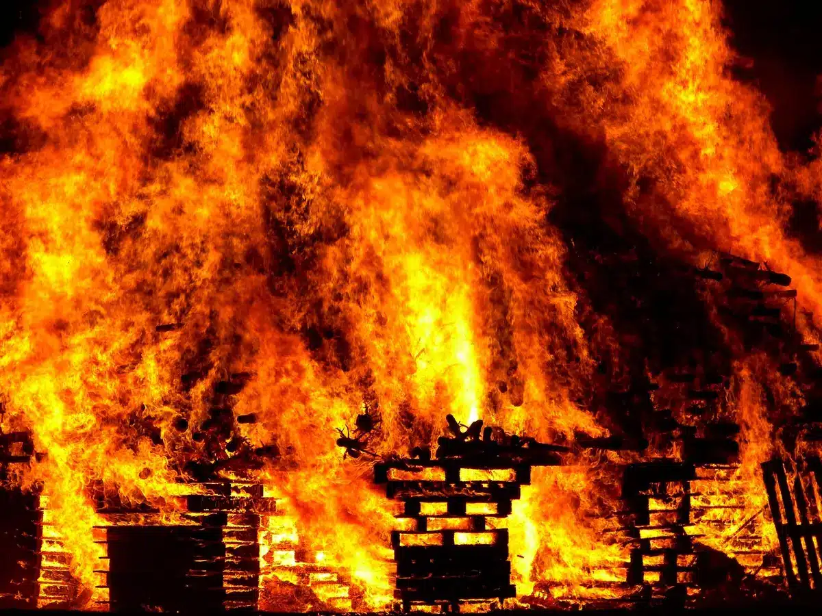 Sparks falling from stage pyrotechnics toward arena rafters during a concert