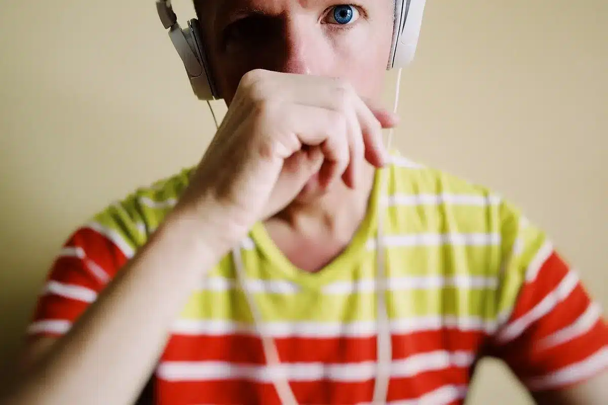 Person wearing headphones in a calm room listening attentively