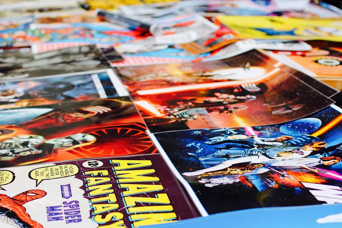 anonymous crowd of readers at a comics convention browsing table, blurred faces, hands holding graphic novels