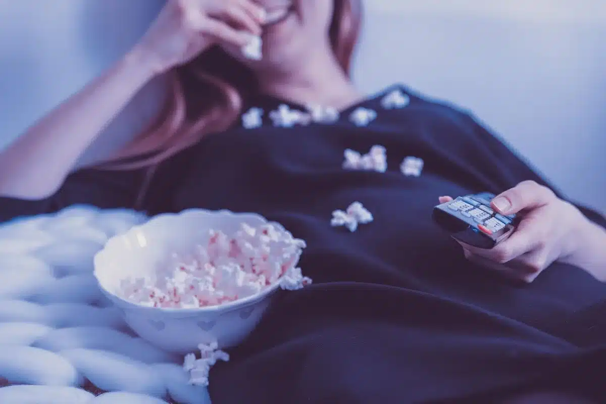 People watching a streaming service at home, reacting nostalgically