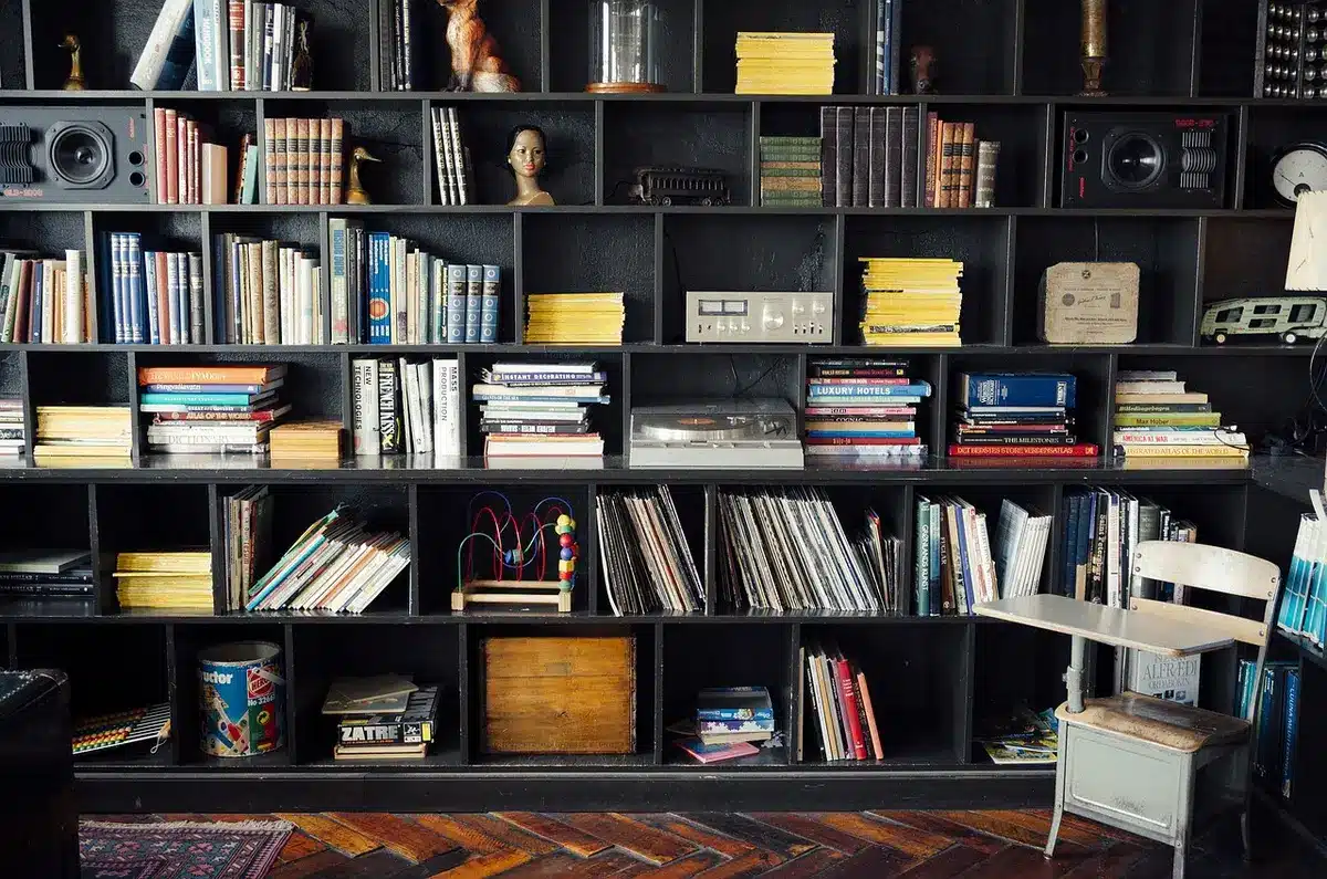 Stack of compilation vinyl records and a booklet highlighting a band's career