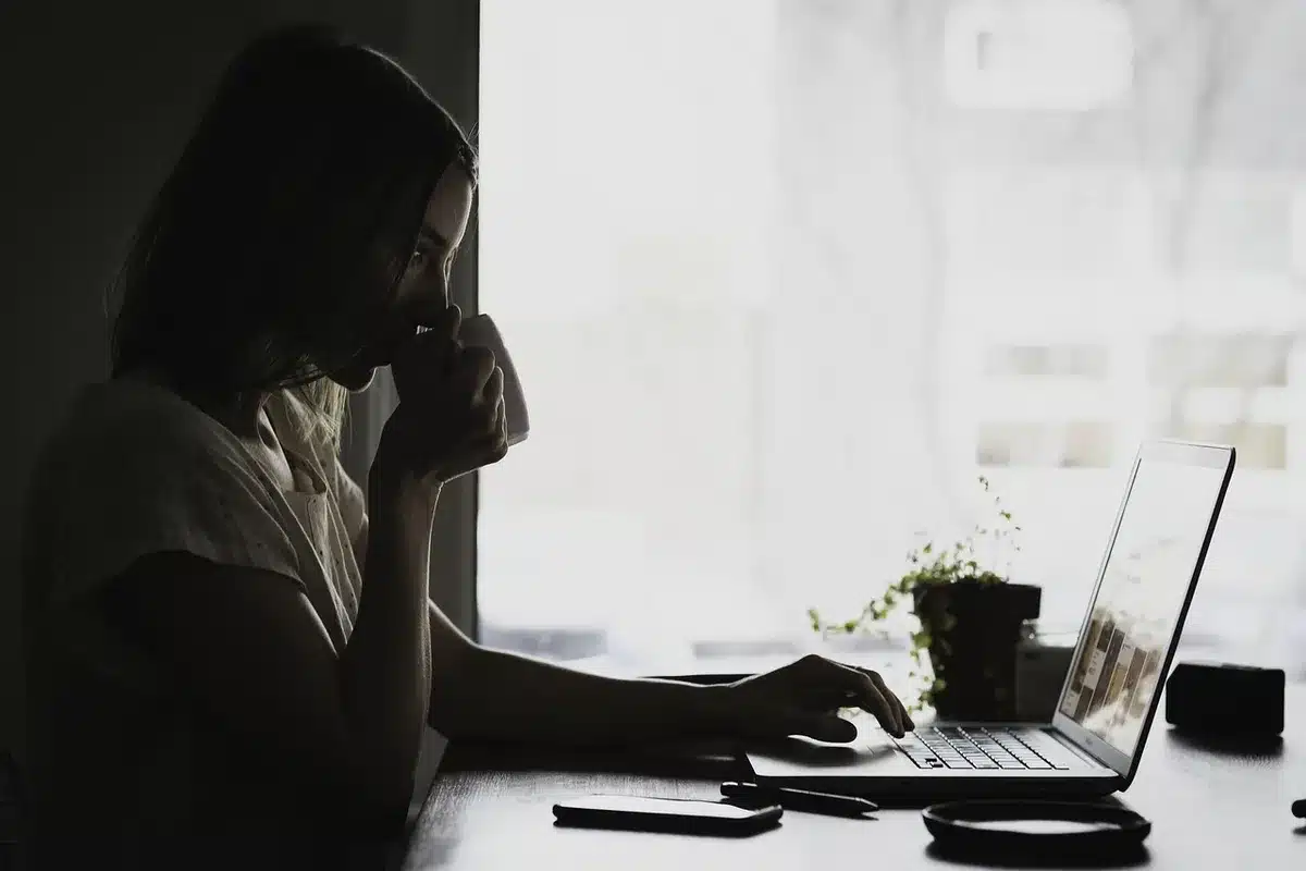 Anonymous silhouette of a woman in a mansion interior reflecting alone