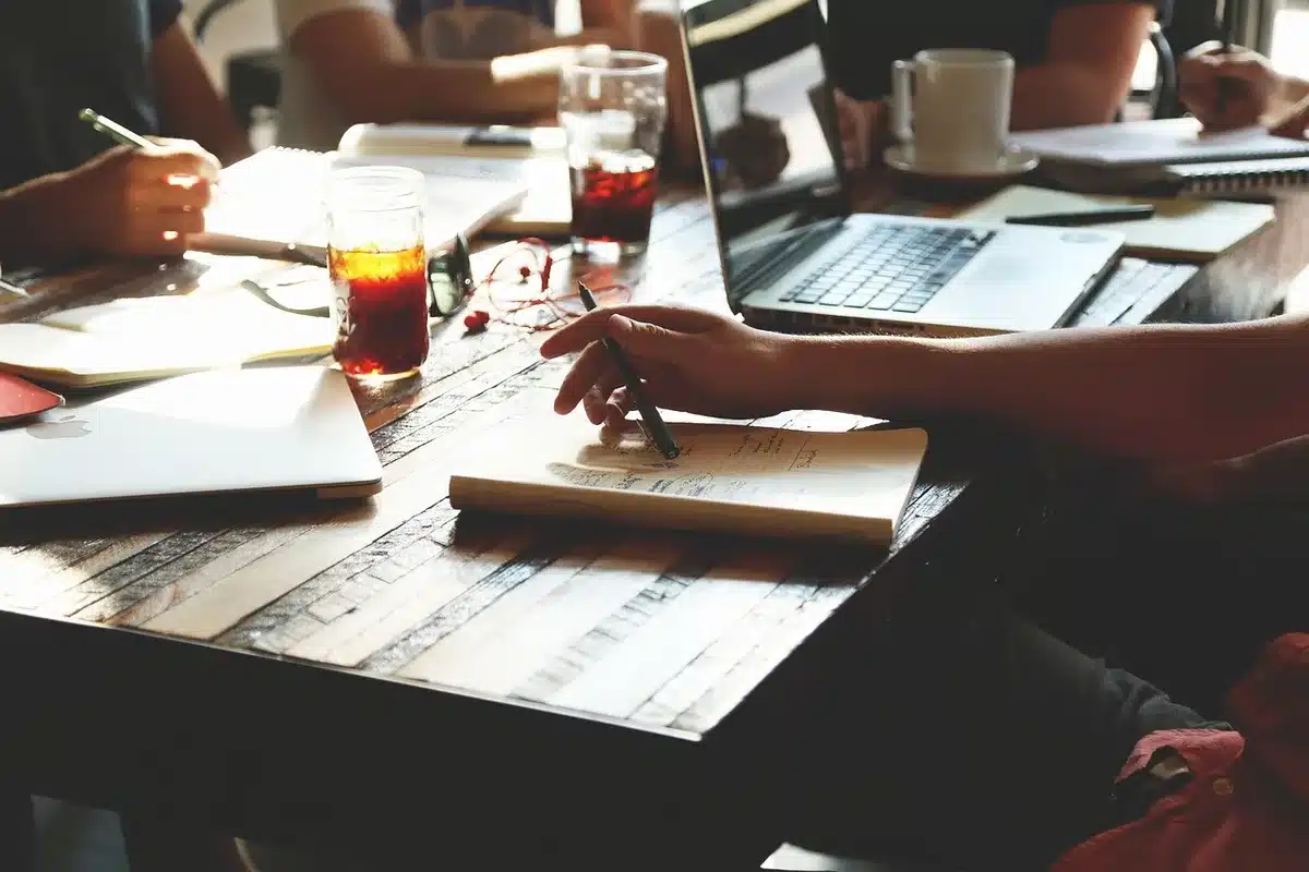 A small group of editors in discussion around a table with notes