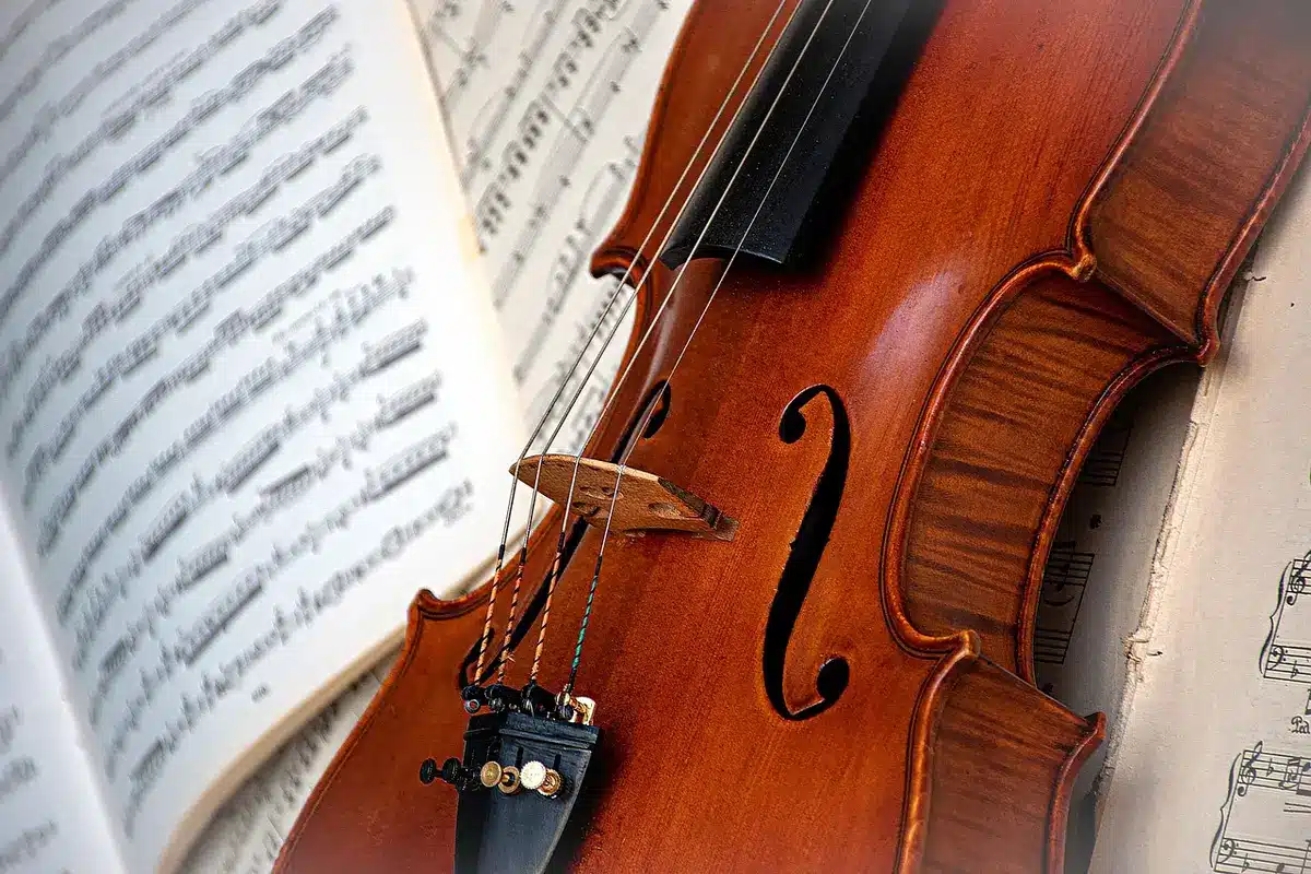 Violinist and composer working on a score in a studio