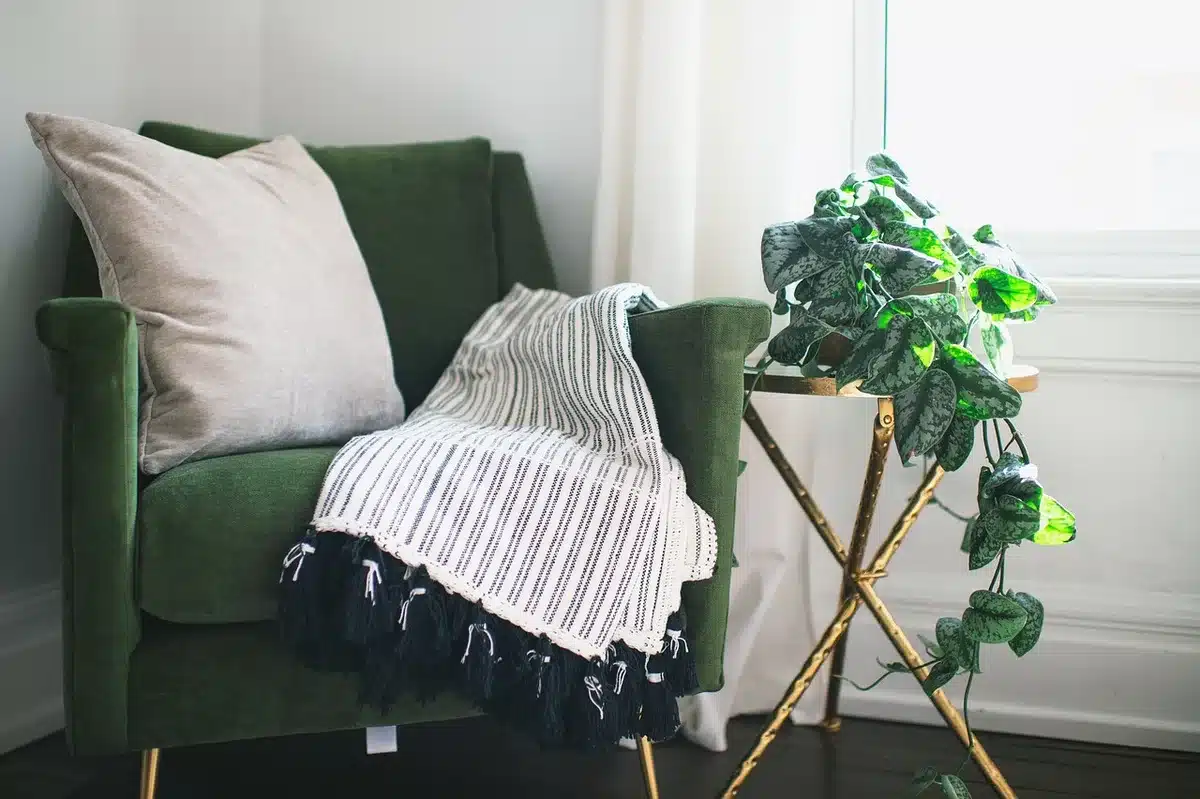 Two people talking on a couch in a living-room set during a filmed conversation