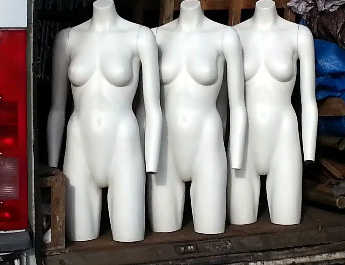 empty comic-shop display with three anonymous horror-themed covers placed face-out, dim interior lighting, no logos