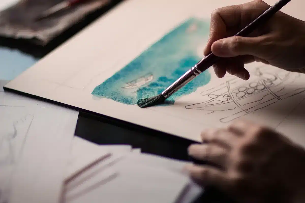 Artist workspace with paints and sketches hinting at atmospheric comic art