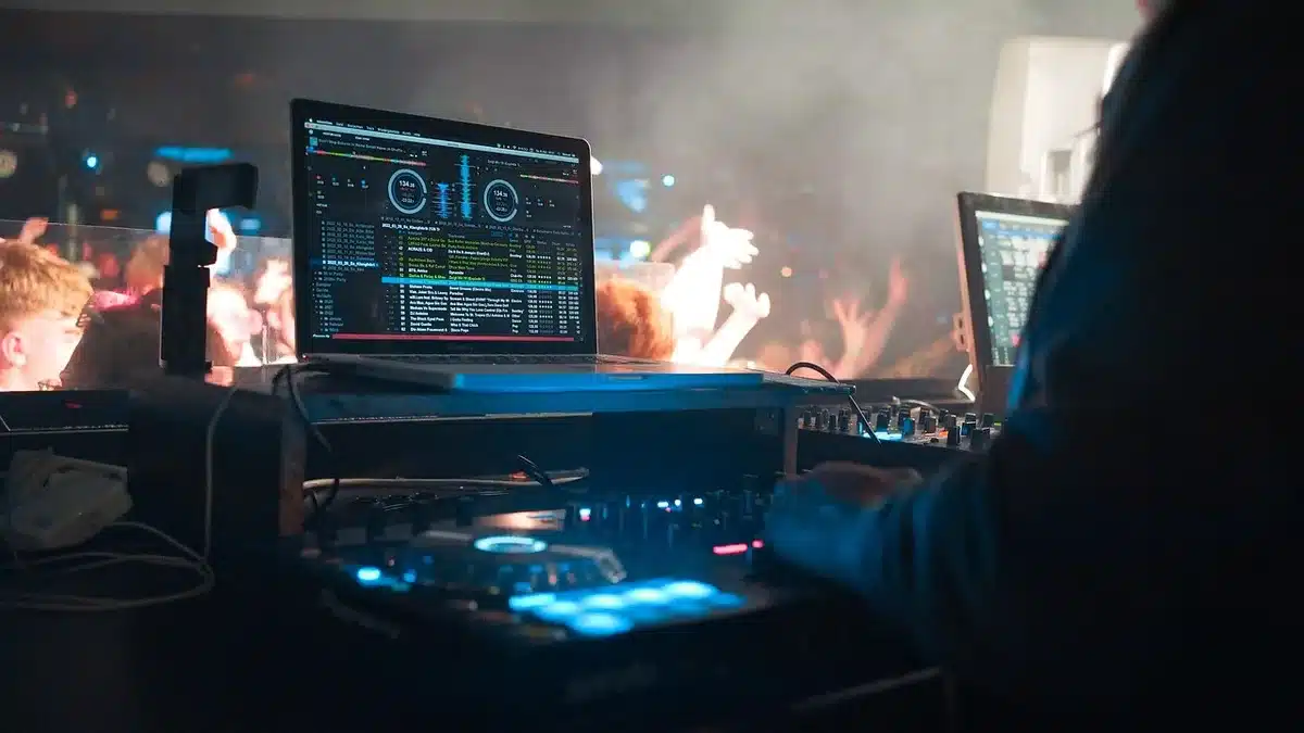Crowd in a dark club with electronic lighting, representing crossover of underground music and horror licensing