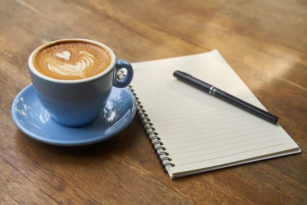 Script pages and a notebook on a production table representing a performer moving to directing