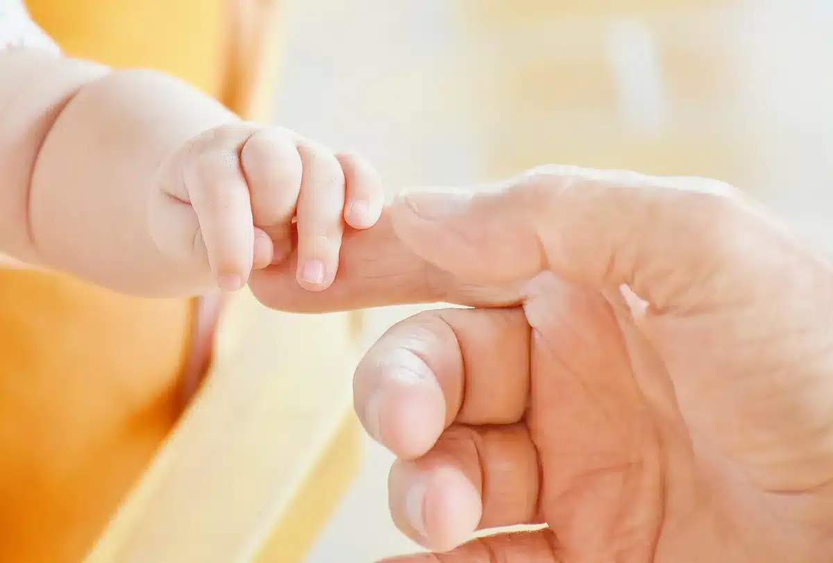 Parents holding their newborn in a hospital room