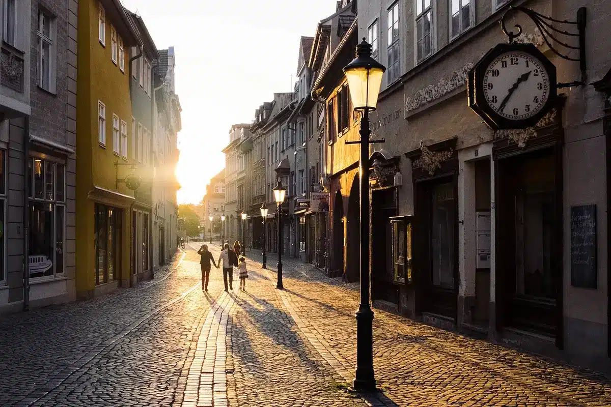 Two men reuniting on a small town street, seen from a distance