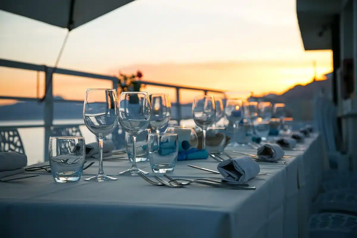 An empty bookseller table with stacked unbranded minicomic copies, a paper price tag, and a small artist card partly visible but unreadable