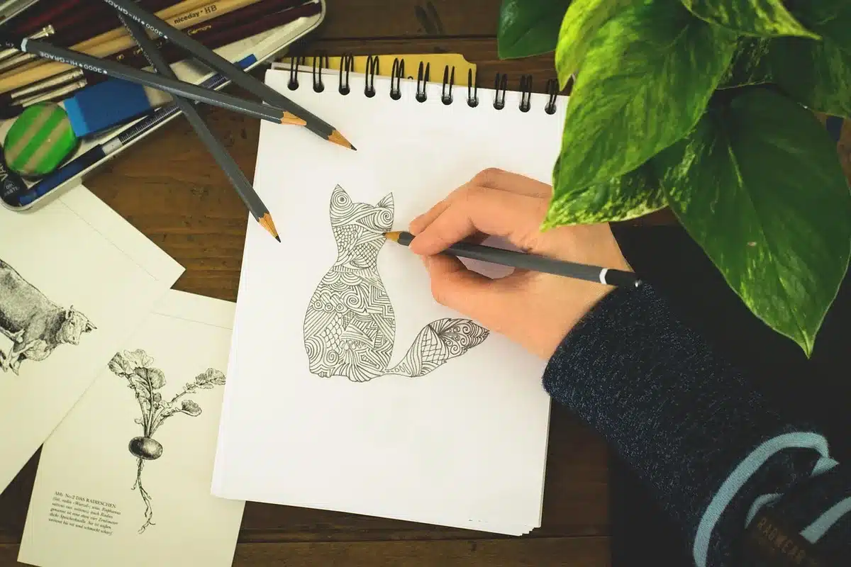 Artist workspace with inks and pencils hinting at a comic artist's return