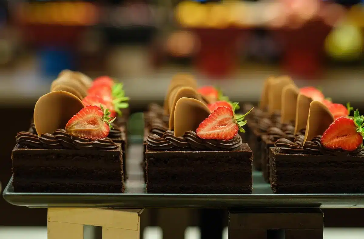 Dessert platter and hands reaching in during a celebratory dinner